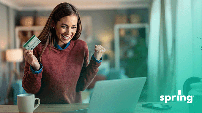 Woman holding instant approval credit card