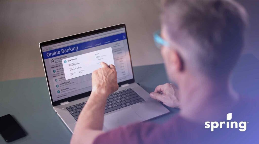 Man looking on his computer at best banks in Canada for a chequing account